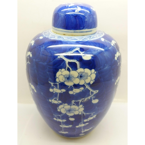 619 - A 19th Century blue and white prunus decorated ginger jar and cover, 21cm