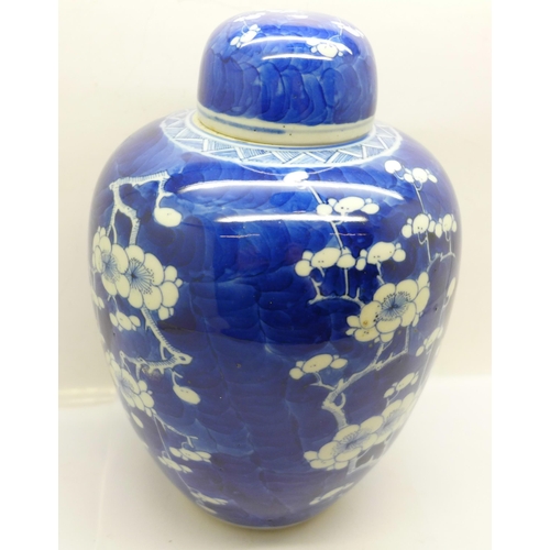 619 - A 19th Century blue and white prunus decorated ginger jar and cover, 21cm