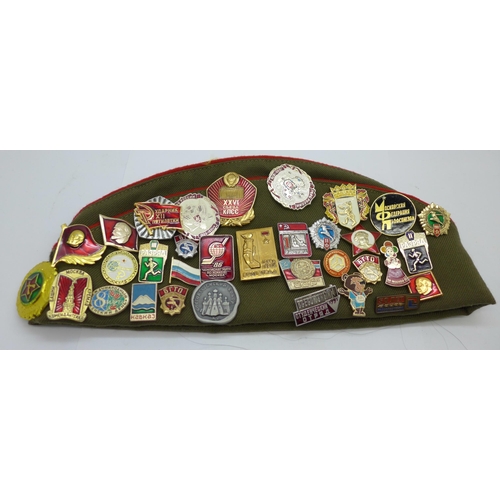 622 - A Soviet cap with a collection of badges