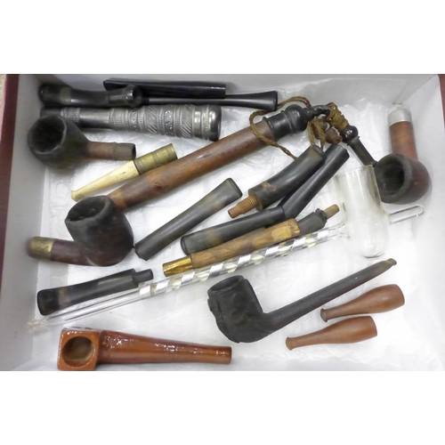 718 - A collection of pipe cases, stems, bowls and a glass pipe, etc.