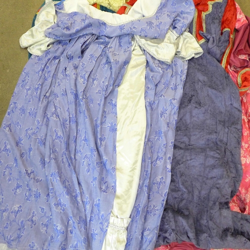 744 - A collection of theatrical Tudor and Georgian ladies dresses, some with hats/head gear