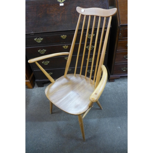 124 - An Ercol Blonde elm and beech plank dining table and six Goldsmith chairs