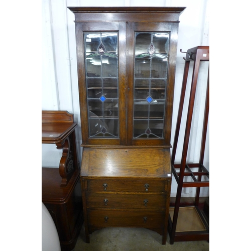 152 - An early 20th Century oak and stained glass bureau bookcase