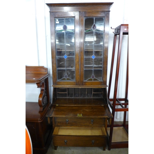 152 - An early 20th Century oak and stained glass bureau bookcase