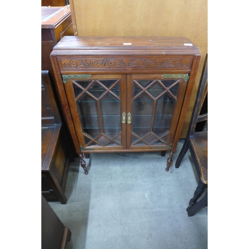 161 - A small mahogany two door display cabinet