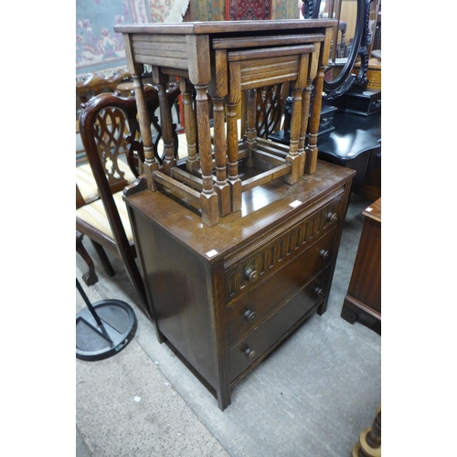 199 - A carved oak chest of drawers and an oak nest of tables