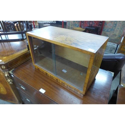 203 - A small walnut table top cabinet