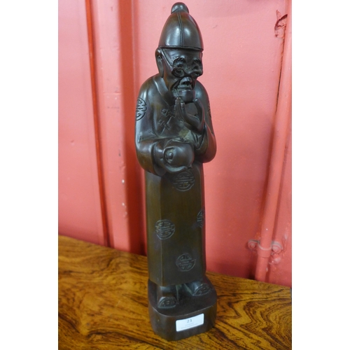 21 - An oriental carved hardwood figure of a sage