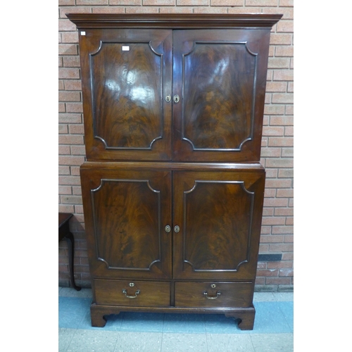 25 - A George III mahogany four door estate cupboard