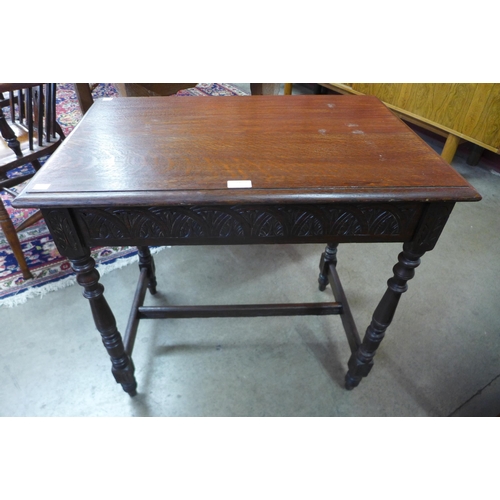 27 - An early 20th Century Edwards & Roberts carved oak occasional table