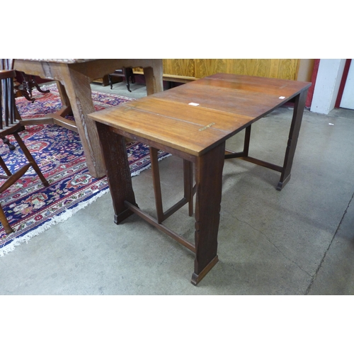 28 - A Cotswold School walnut folding coffee table