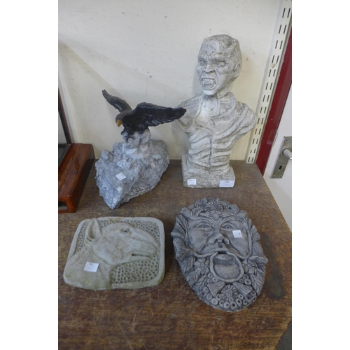 346 - A concrete bust of a goblin, an English Bull Terrier concrete plaque and two others