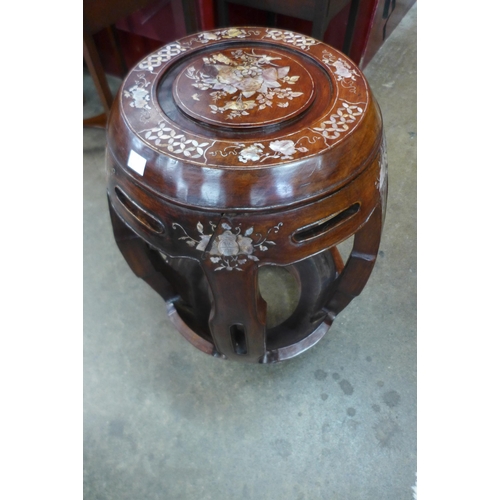 42 - A Chinese hardwood and mother of pearl inlaid barrel shaped stool