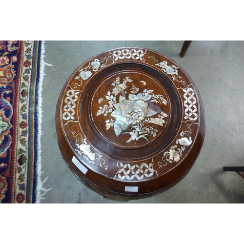 42 - A Chinese hardwood and mother of pearl inlaid barrel shaped stool