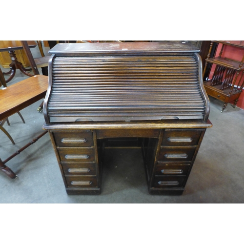 45 - An early 20th Century oak tambour roll top desk