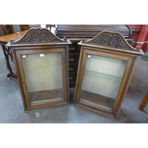 46 - A pair of 19th Century carved walnut wall hanging cabinets