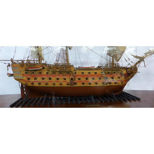 58 - A large cased model of H.M.S. Victory, case dimensions; 93cms h, 132cms w, 38cms d