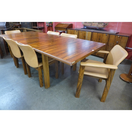 61 - A Danish rosewood extending dining table (71cms h, 101cms w, 182cms l (233cms l extended) and six ch... 