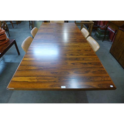 61 - A Danish rosewood extending dining table (71cms h, 101cms w, 182cms l (233cms l extended) and six ch... 