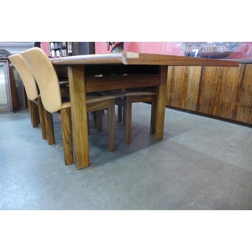 61 - A Danish rosewood extending dining table (71cms h, 101cms w, 182cms l (233cms l extended) and six ch... 