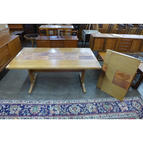 88 - A Danish oak and tiled top extending dining table