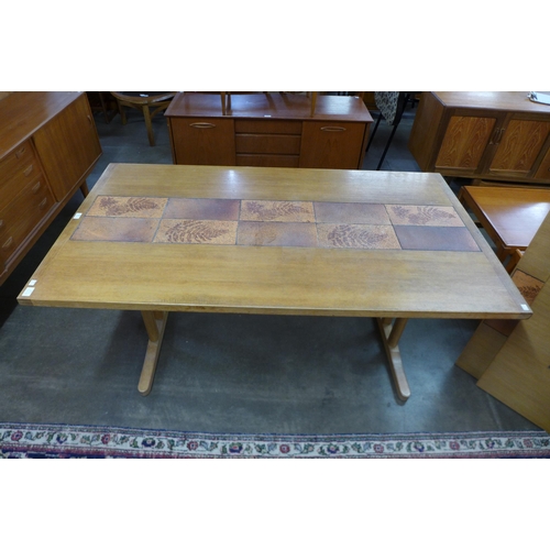 88 - A Danish oak and tiled top extending dining table