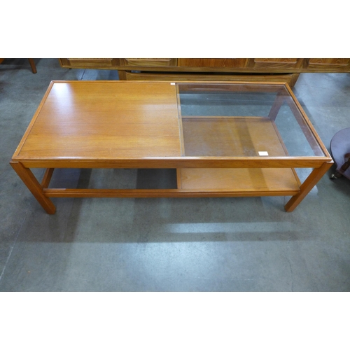 93 - A teak and glass topped coffee table