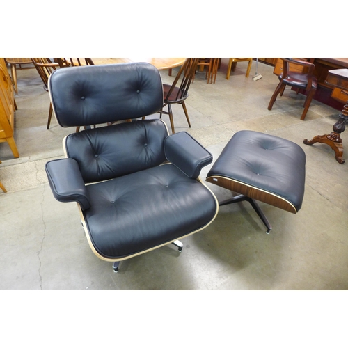 96 - A Charles & Ray Eames style black leather and simulated walnut revolving lounge chair and stool