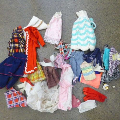 730 - A large collection of Sindy clothing, footwear, accessories, etc., and nine dolls