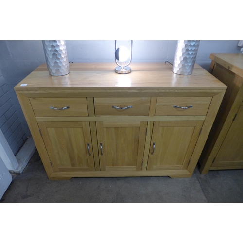 1339 - An oak three door sideboard slight marks