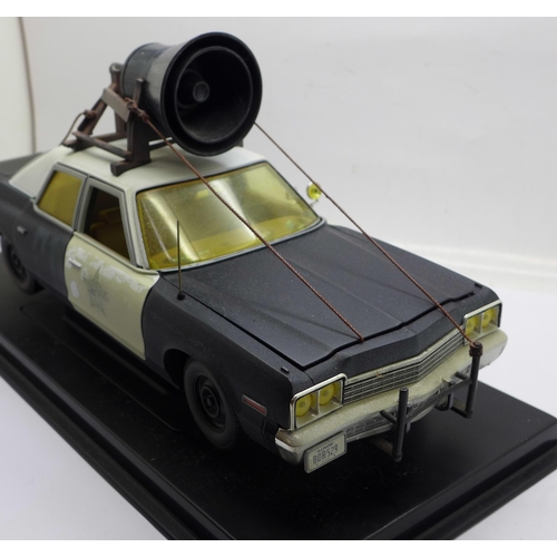 652 - A heavy die-cast model Blues Brothers police car on a plinth, 31cm