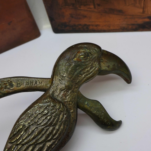 686 - A pair of late Victorian novelty parrot nutcrackers and two copper printing plates of corner shops