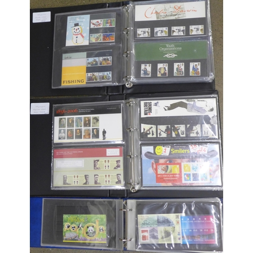 708 - A collection of approximately 130 Royal Mail mint stamp packs and a collection of First Day Covers