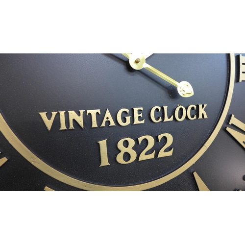 1352 - A large round embossed black and gold wall clock, H79cms (CL215238)   #