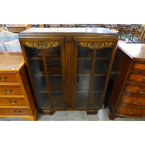 100 - A carved oak two door bookcase