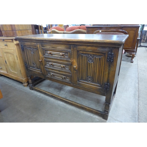 108 - A carved oak linenfold dresser