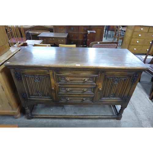 108 - A carved oak linenfold dresser