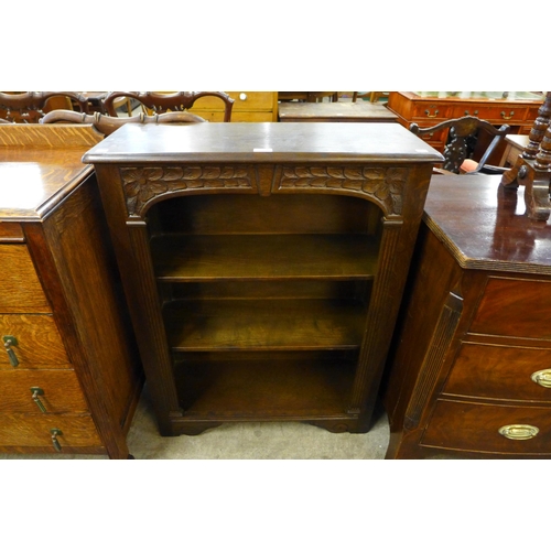 110 - A carved oak open bookcase