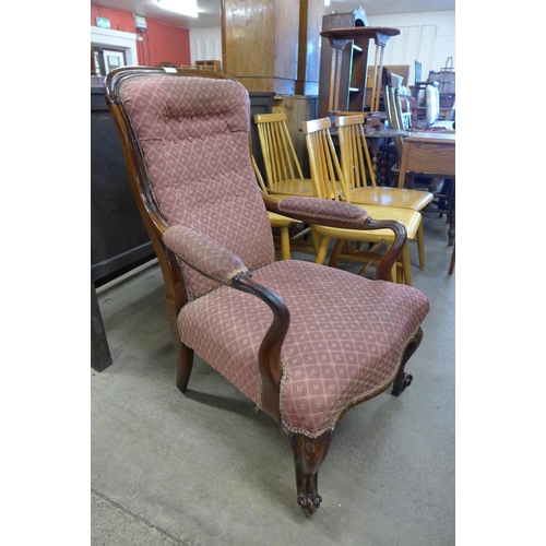 147 - An early Victorian rosewood and upholstered open armchair