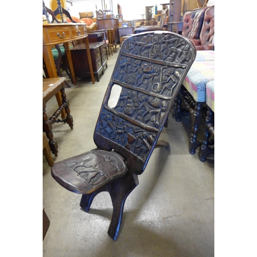 157 - An African carved hardwood birthing chair