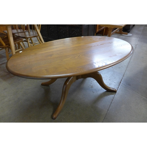 172 - An Ercol Golden Dawn elm oval coffee table