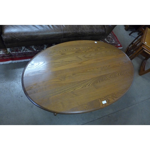 172 - An Ercol Golden Dawn elm oval coffee table