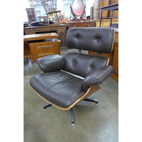 71 - A Charles & Ray Eames style simulated rosewood and brown leather revolving lounge chair