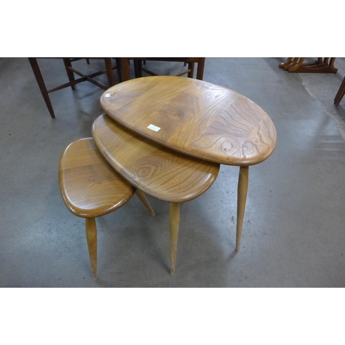 77 - An Ercol Blonde elm and beech pebble shaped nest of tables