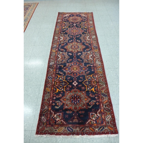 7C - A north west Iranian red ground runner rug, 298 x 95cms