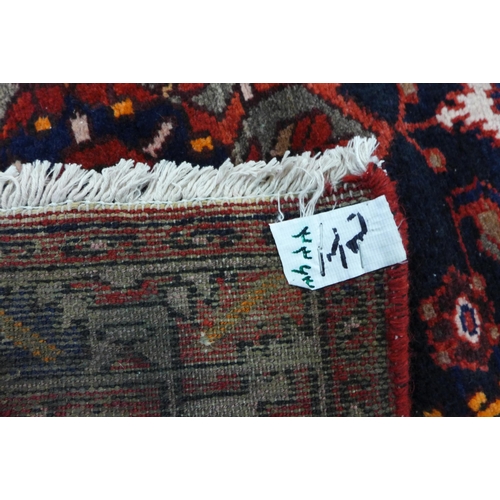 7C - A north west Iranian red ground runner rug, 298 x 95cms