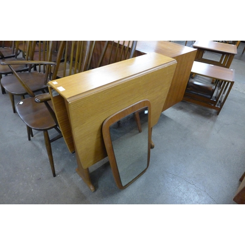 93 - A teak drop leaf table and a teak framed mirror