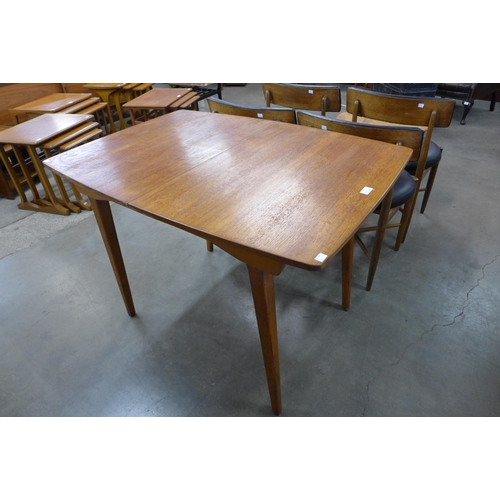 95 - A teak extending dining table