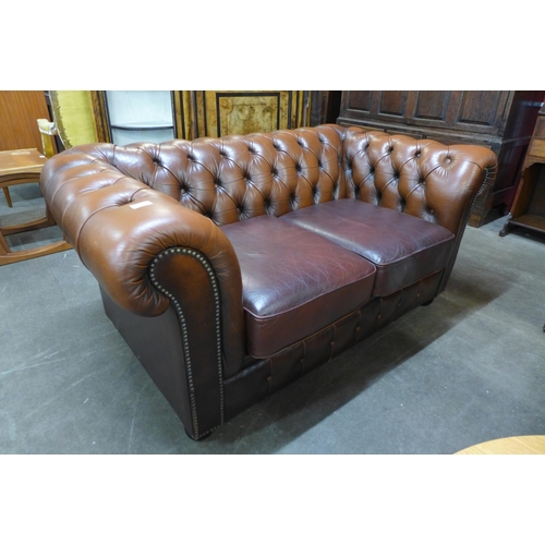 231 - A brown leather Chesterfield settee