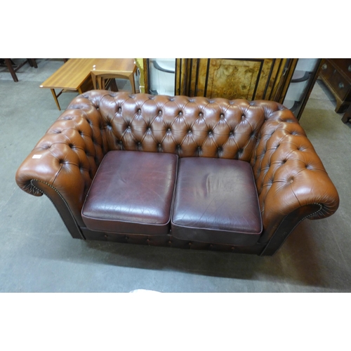 231 - A brown leather Chesterfield settee